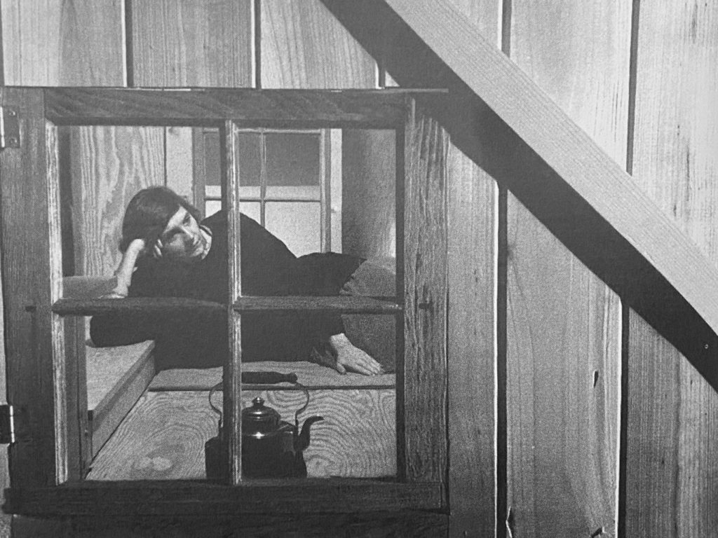 Black and white photo of Ann Cline inside her backyard house