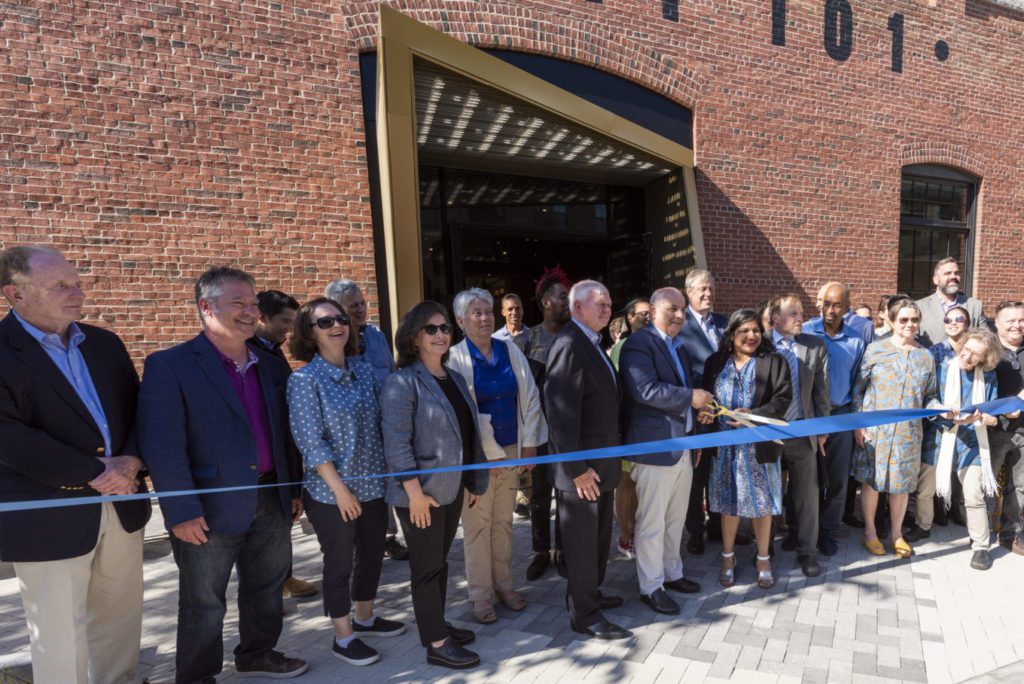 People stand outside the Foundry's main entrance for the ribbon cutting ceremony