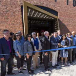 People stand outside the Foundry's main entrance for the ribbon cutting ceremony