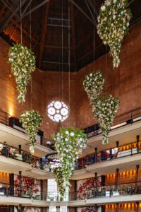 The Liberty Hotel Lobby decorated with hanging upside-down Christmas trees for the holiday season