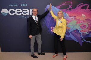 WHOI President Peter de Menocal and Scripps Oceanographic Institution President Margaret Leinen pose outside the Ocean Pavilion.