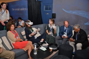 COP28 visitors and WHOI staff relax in the lounge space at the Ocean Pavilion