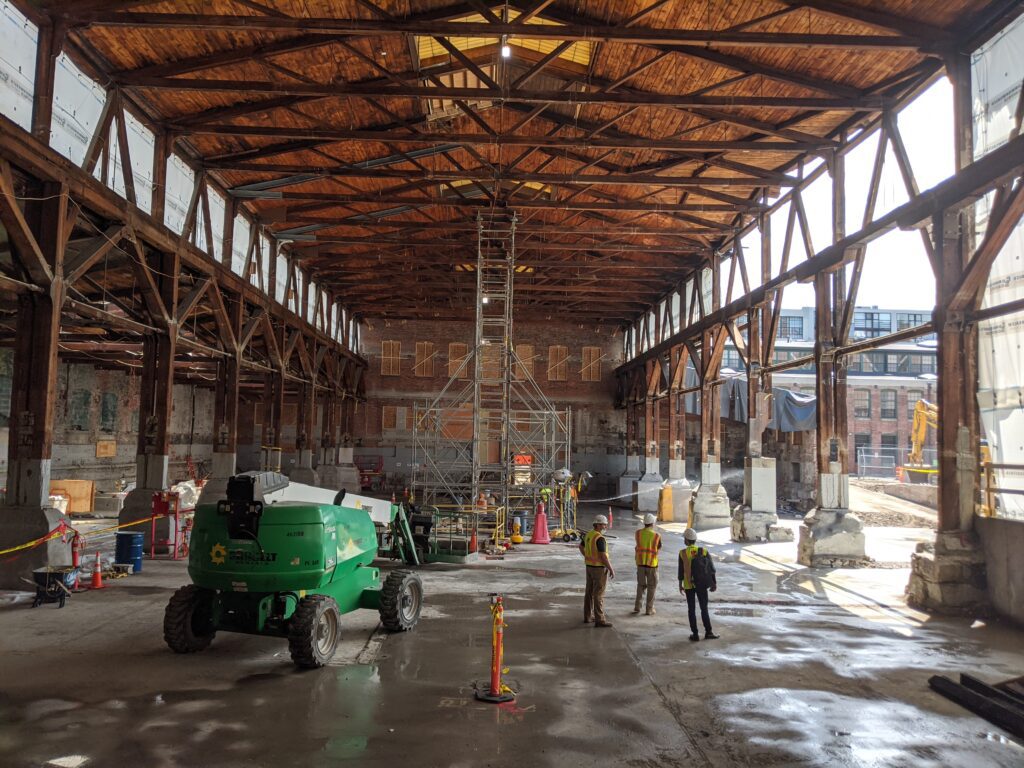 Team of architects analyze the foundation and structure of old steam pump factory to assess renovation and restoration possibilities. 