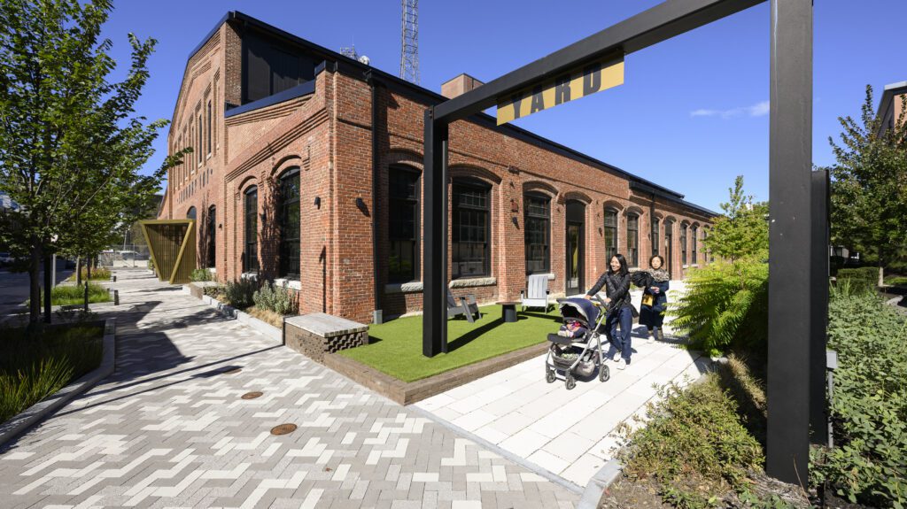 At Foundry 101, "The Yard" incorporates bicycle parking, native plantings and trees, and light-colored surfaces into the design.